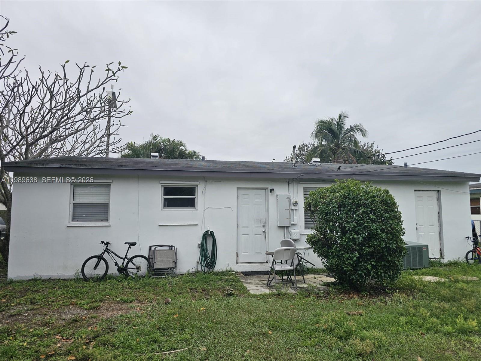 569 Tallulah Road Lake Worth, FL 33462 - Photo 31 of 40 a view of a backyard with table and chairs