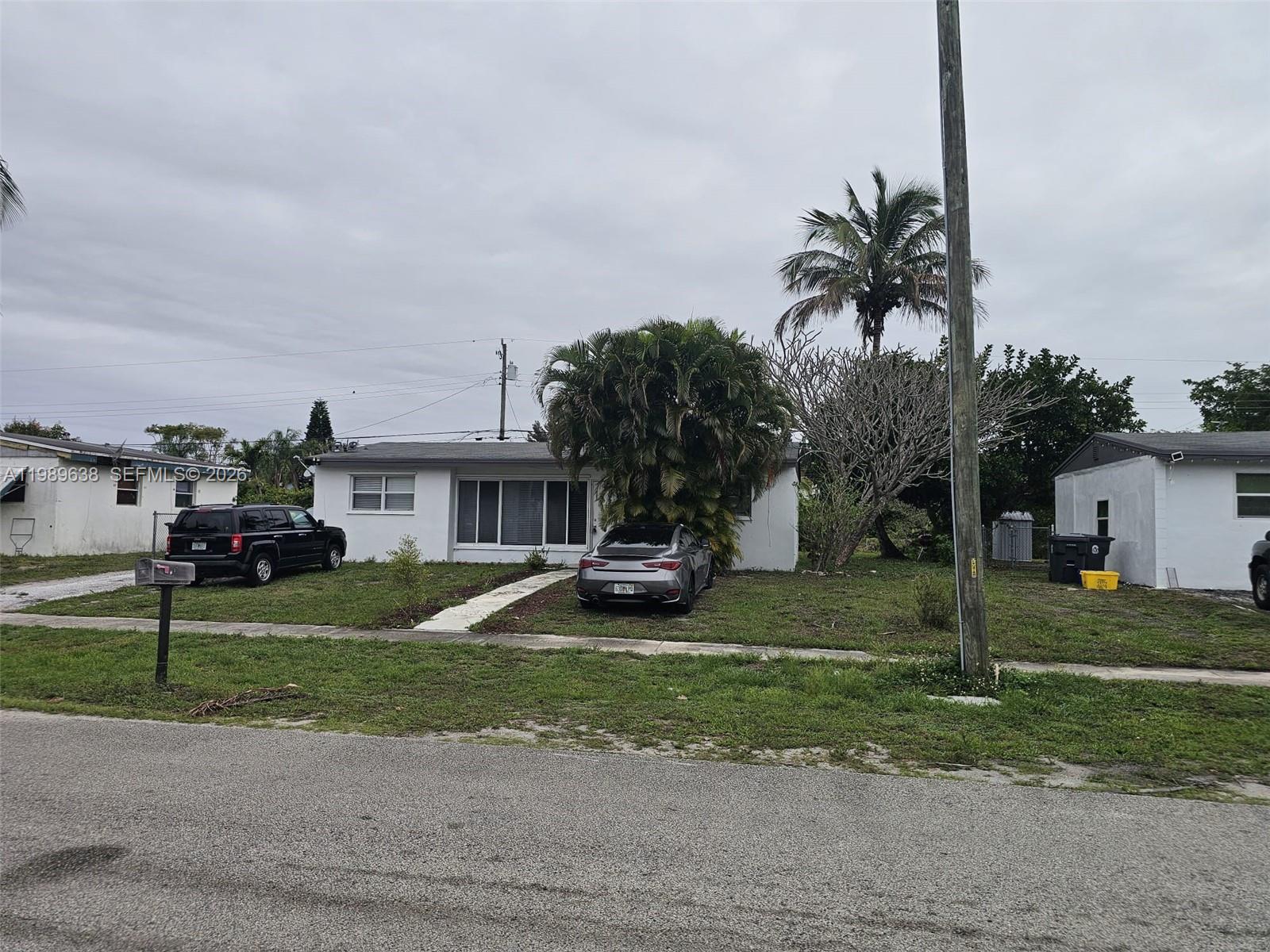 569 Tallulah Road Lake Worth, FL 33462 - Photo 32 of 40 a view of a house with a yard and street