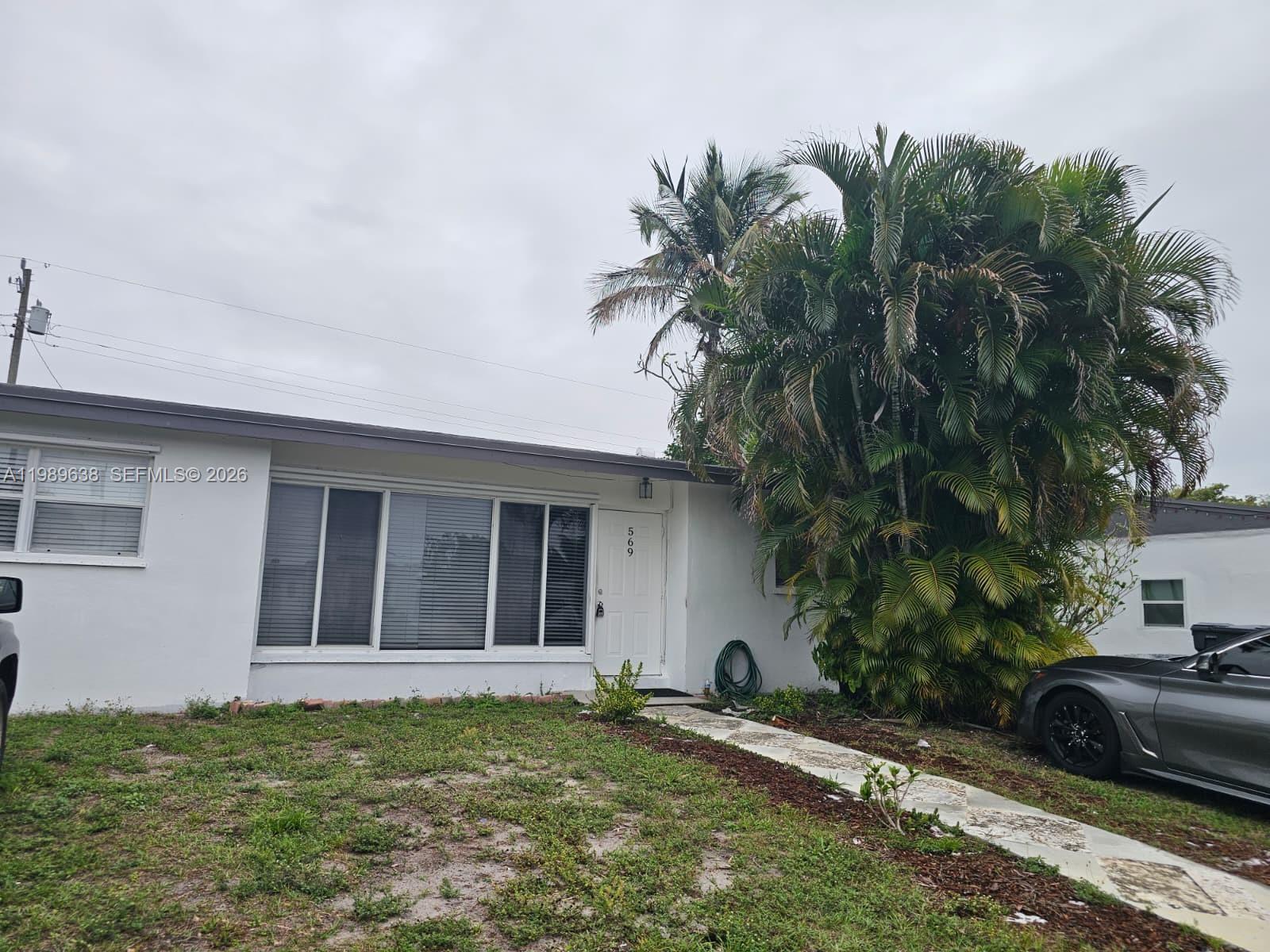 569 Tallulah Road Lake Worth, FL 33462 - Photo 39 of 40 a house with a tree in front of it
