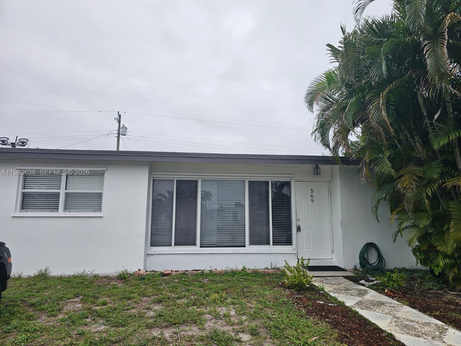 569 Tallulah Road Lake Worth, FL 33462 - Photo 40 of 40 a front view of a house with garden