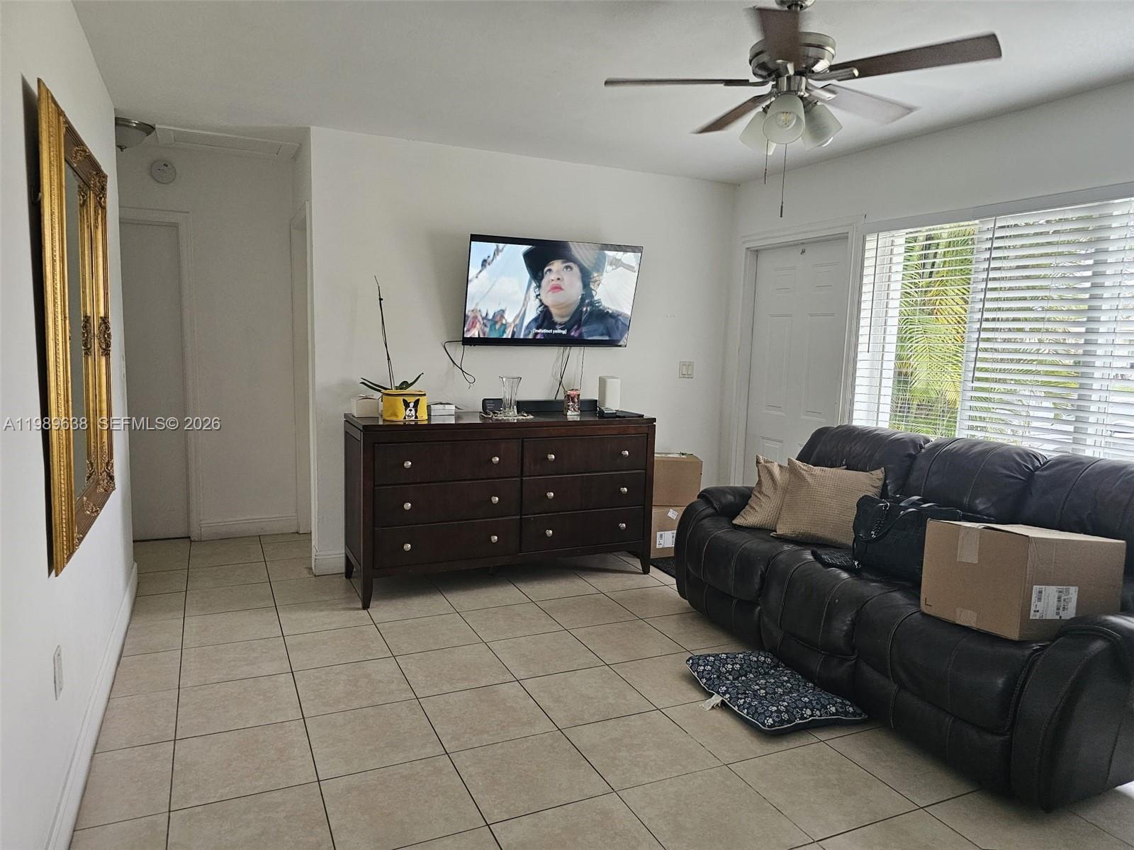 569 Tallulah Road Lake Worth, FL 33462 - Photo 4 of 40 a living room with furniture and a flat screen tv