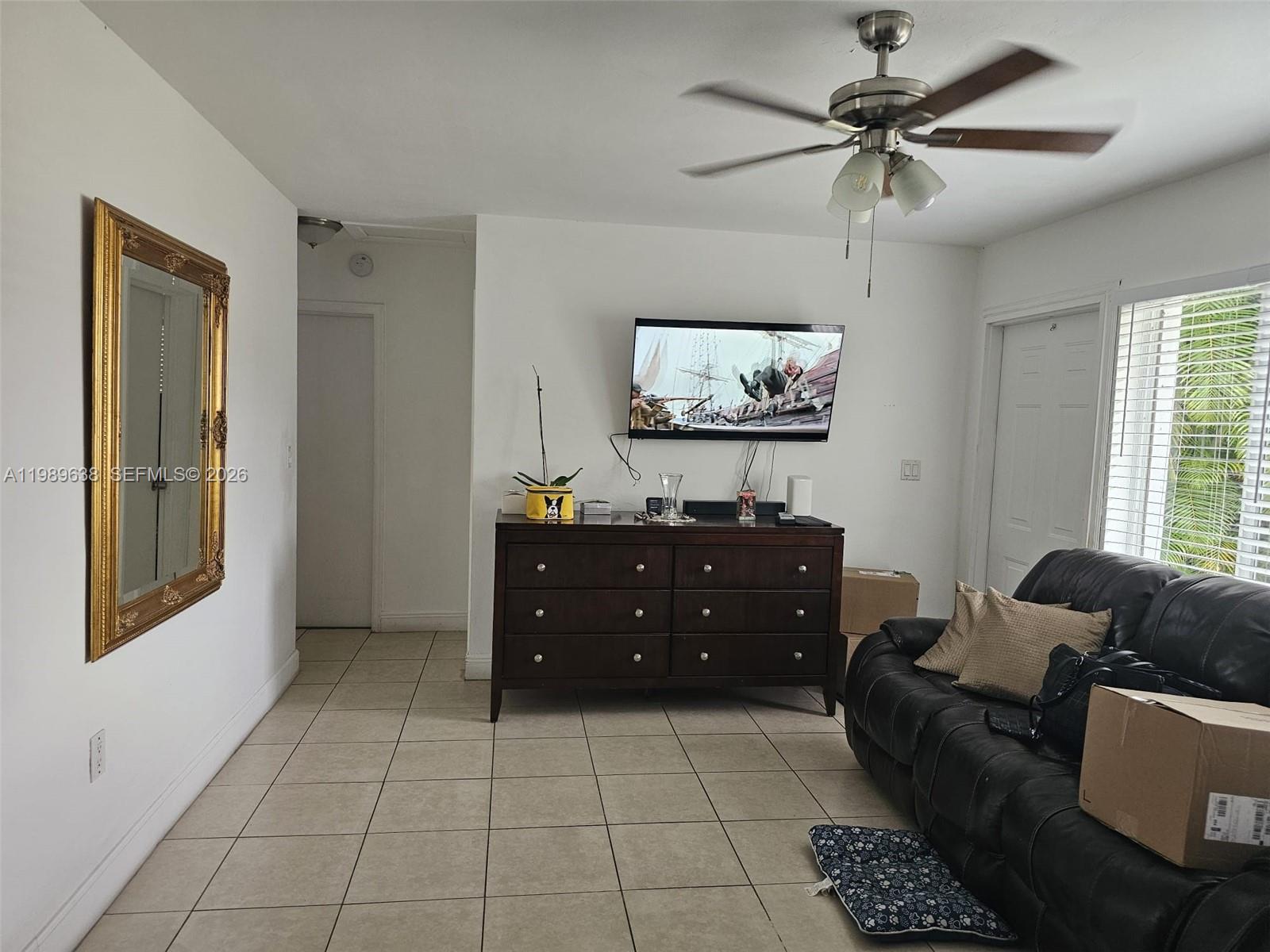 569 Tallulah Road Lake Worth, FL 33462 - Photo 5 of 40 a living room with furniture and a flat screen tv