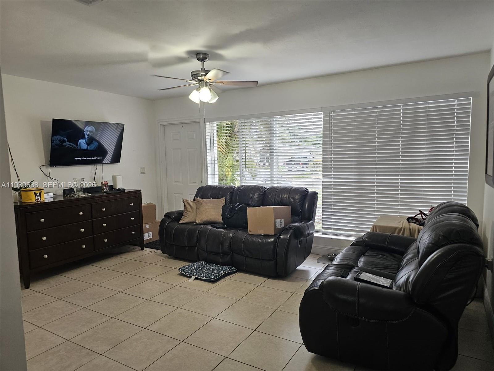 569 Tallulah Road Lake Worth, FL 33462 - Photo 9 of 40 a living room with furniture and a flat screen tv