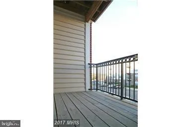 a view of a balcony with wooden floor