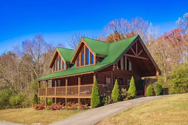 a view of a house with a yard and potted plants
