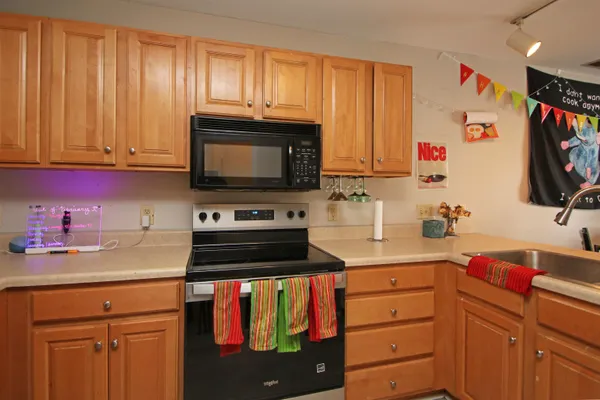 a kitchen with granite countertop a sink stainless steel appliances and cabinets
