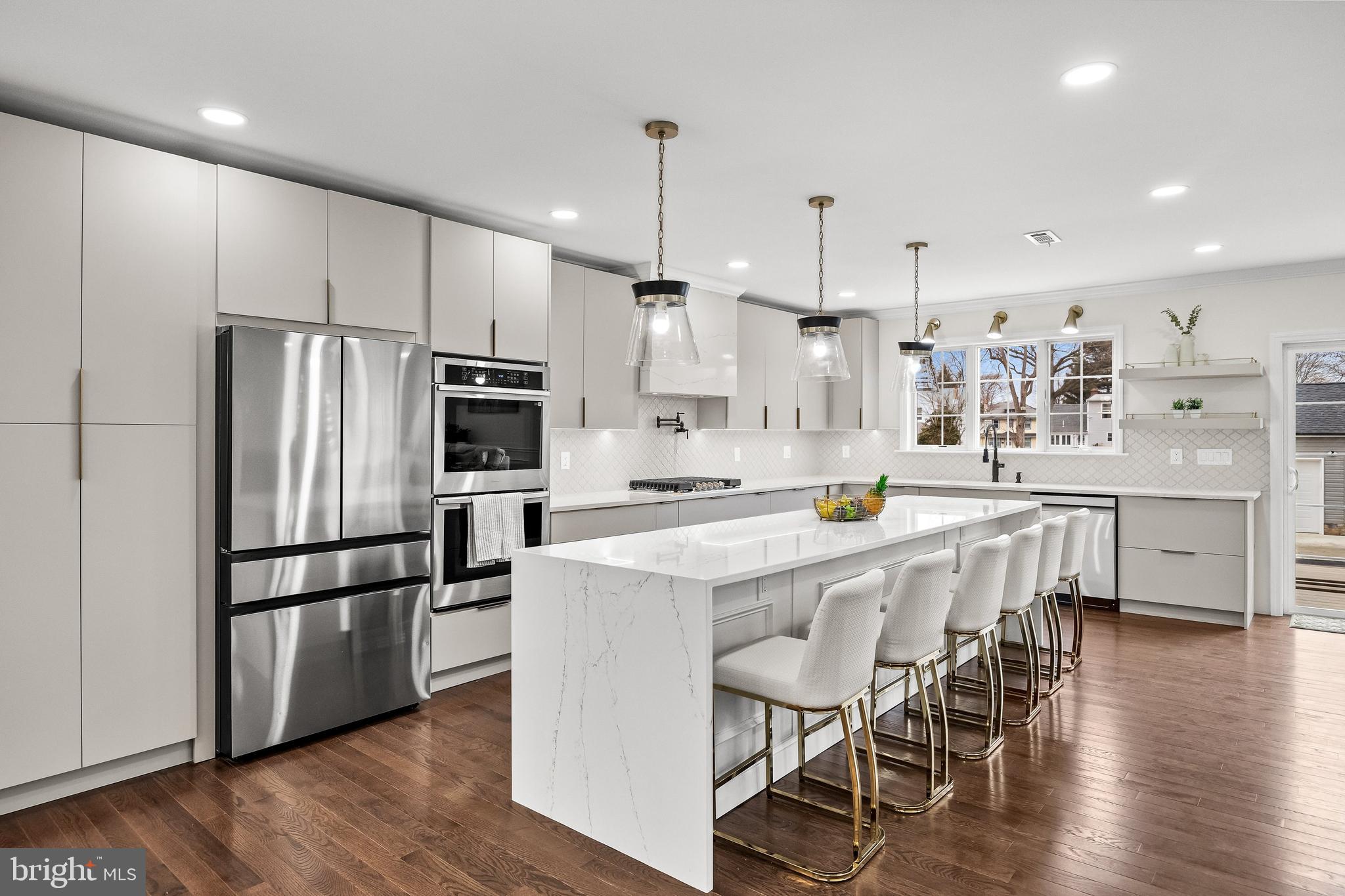 15 Cuthbert Boulevard Haddon Township, NJ 08107 - Photo 13 of 60 a kitchen with stainless steel appliances granite countertop a refrigerator a stove a sink a dining table and chairs with wooden floor