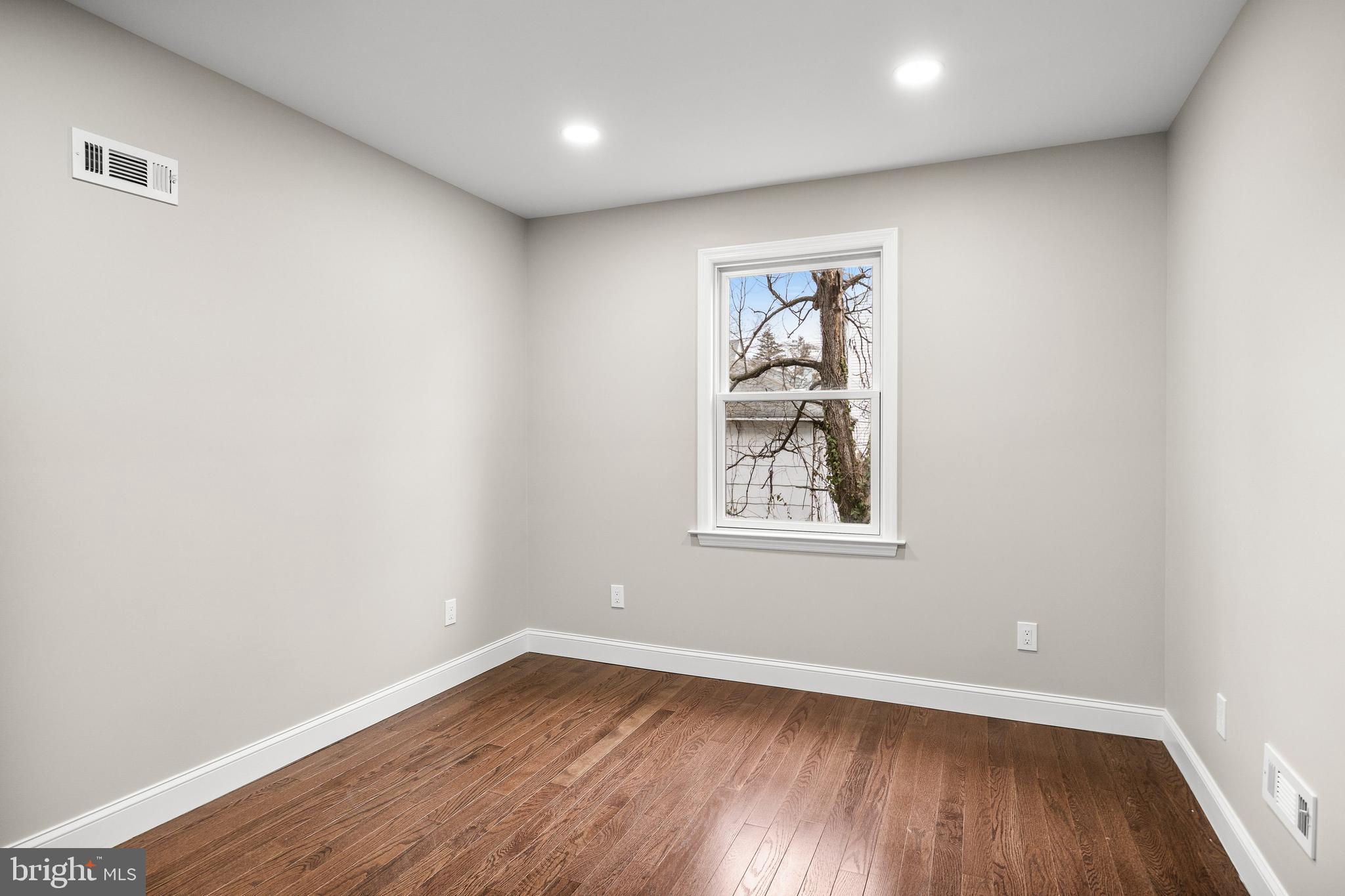 15 Cuthbert Boulevard Haddon Township, NJ 08107 - Photo 35 of 60 an empty room with wooden floor and window
