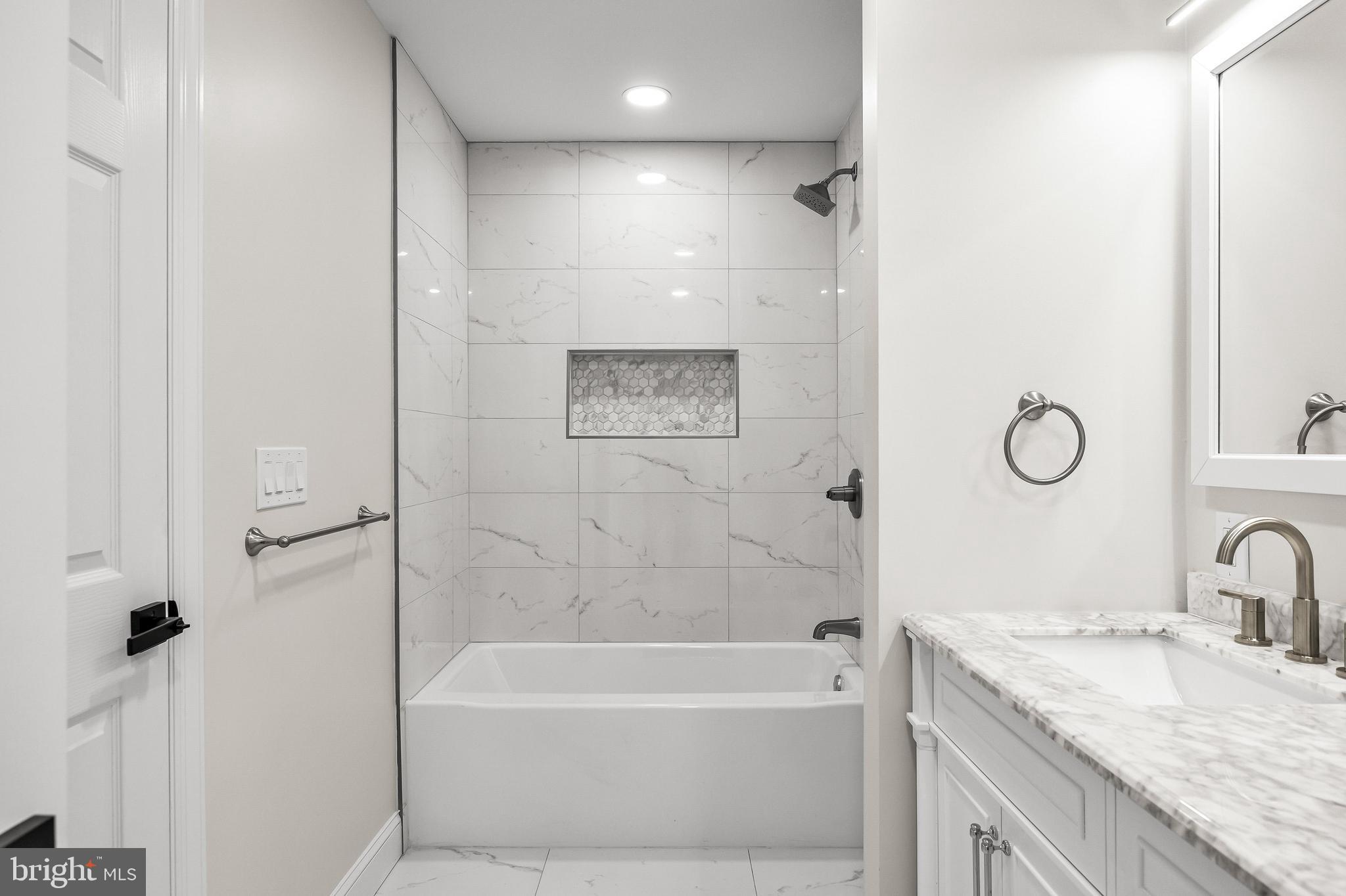 15 Cuthbert Boulevard Haddon Township, NJ 08107 - Photo 47 of 60 a bathroom with a granite countertop sink a toilet and bathtub