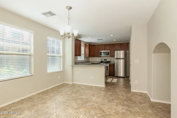 a view of a kitchen with refrigerator and windows