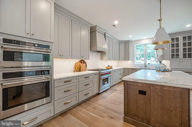 a kitchen with stainless steel appliances a stove a refrigerator and a stove