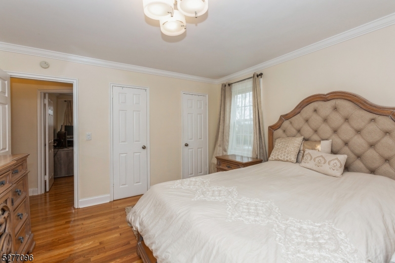 390 Morris Avenue, Unit 29 Summit, NJ 07901 - Photo 12 of 18 a bedroom with a bed and wooden floor