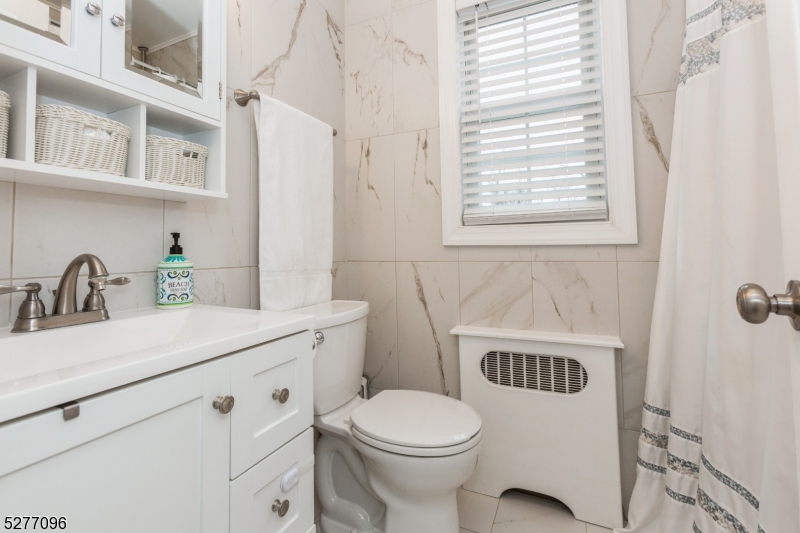 390 Morris Avenue, Unit 29 Summit, NJ 07901 - Photo 13 of 18 a bathroom with a sink a toilet and a window