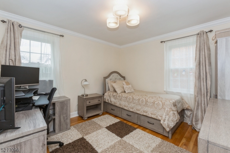 390 Morris Avenue, Unit 29 Summit, NJ 07901 - Photo 14 of 18 a bedroom with a bed window and a flat screen tv