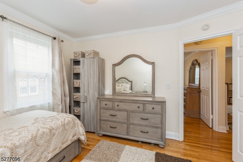 390 Morris Avenue, Unit 29 Summit, NJ 07901 - Photo 15 of 18 a bedroom with a bed and a dresser