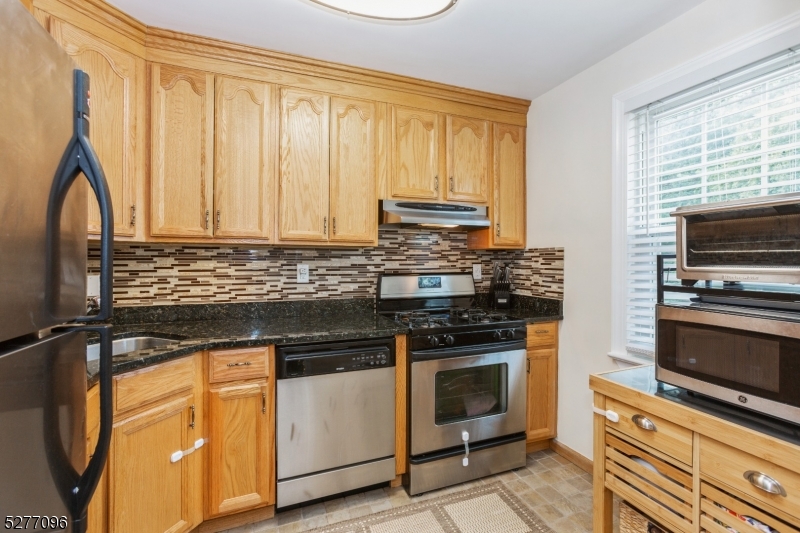 390 Morris Avenue, Unit 29 Summit, NJ 07901 - Photo 17 of 18 a kitchen with a stove a sink and a microwave