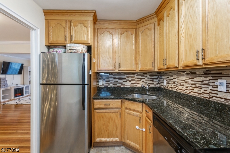 390 Morris Avenue, Unit 29 Summit, NJ 07901 - Photo 18 of 18 a kitchen with a refrigerator a stove and a cabinets