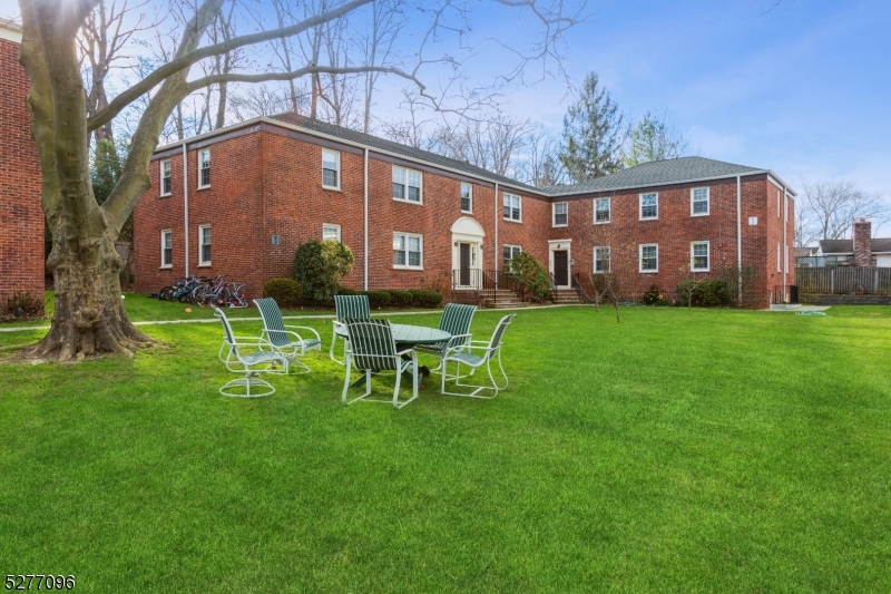 390 Morris Avenue, Unit 29 Summit, NJ 07901 - Photo 3 of 18 a view of a chair and table in the yard