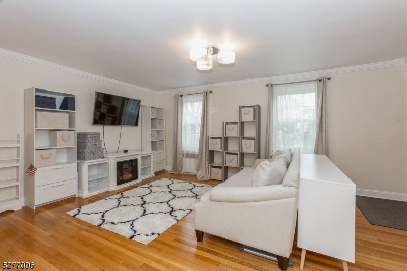 390 Morris Avenue, Unit 29 Summit, NJ 07901 - Photo 8 of 18 a living room with furniture and a flat screen tv