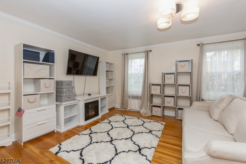 390 Morris Avenue, Unit 29 Summit, NJ 07901 - Photo 9 of 18 a living room with furniture and a flat screen tv
