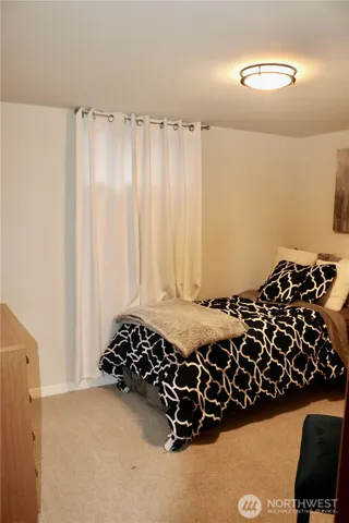 a bed with a black and white comforter