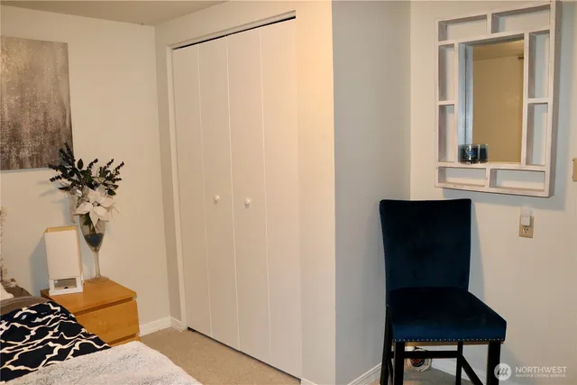 a view of a bedroom with a table and a potted plant