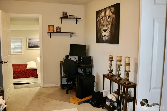 a view of a workspace with furniture and gym equipment