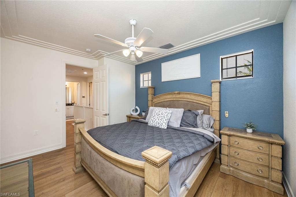 9128 Delano Street, Unit 892 Naples, FL 34113 - Photo 17 of 49 a bedroom with a large bed and chandelier
