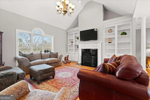 a kitchen with stainless steel appliances granite countertop a kitchen island hardwood floor and a window