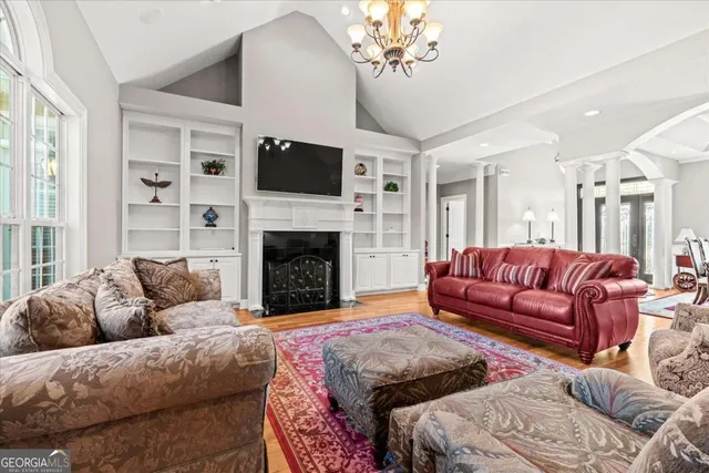 a view of a hallway with a livingroom and furniture