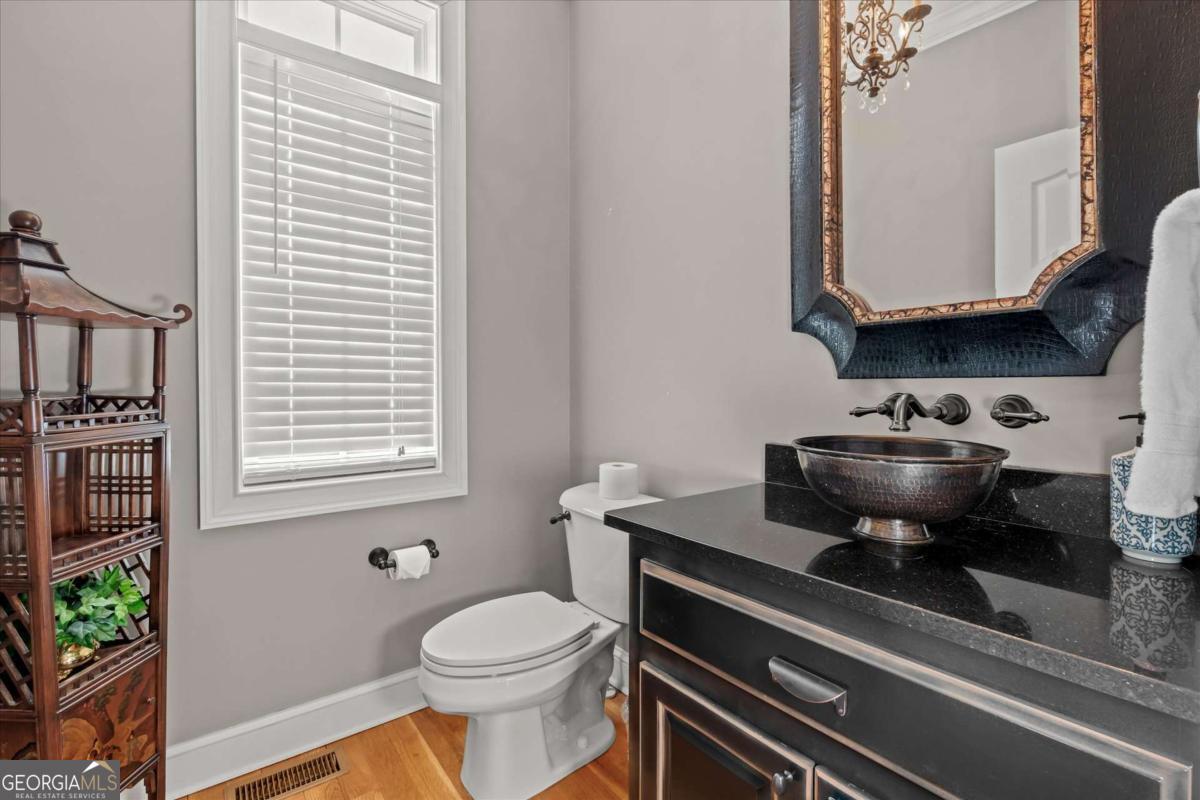 220 McKenzie Bridge Road Carrollton, GA 30117 - Photo 27 of 80 a bathroom with a stove a sink and a window