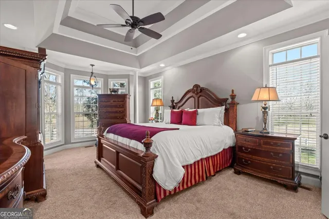 a bedroom with a bed and a chandelier