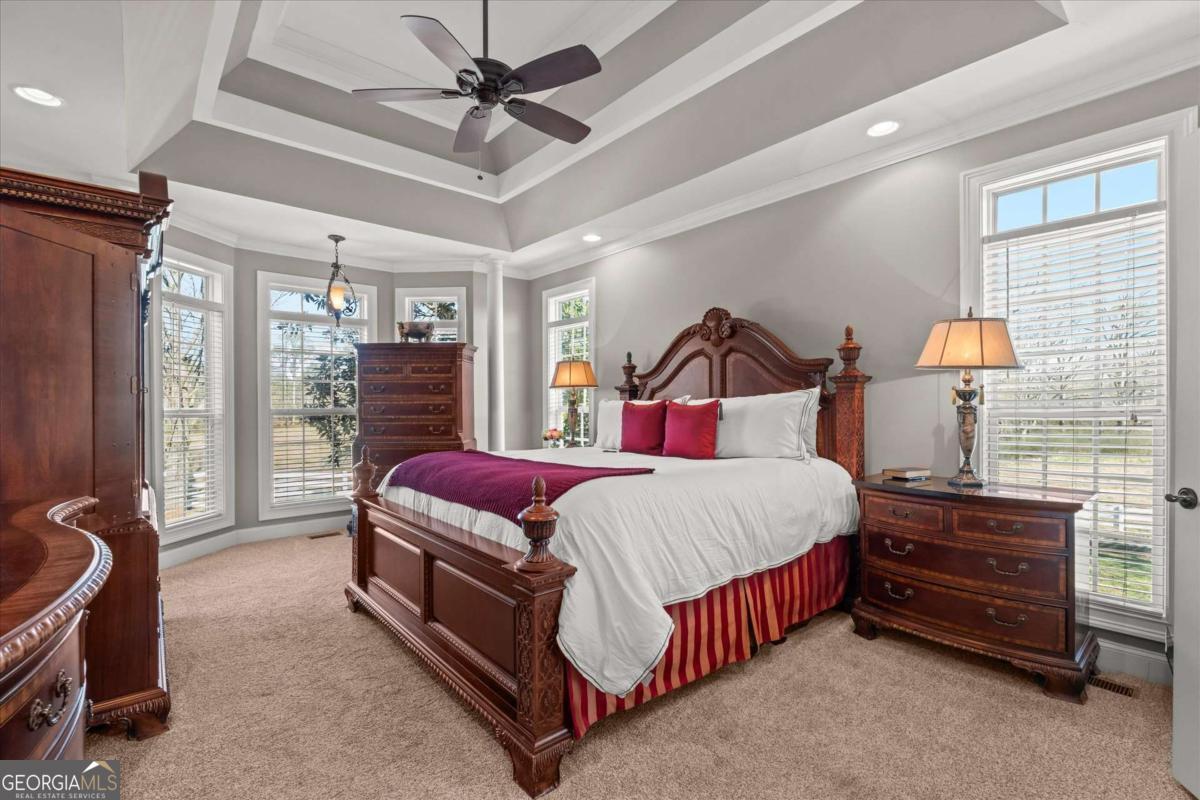 220 McKenzie Bridge Road Carrollton, GA 30117 - Photo 28 of 80 a spacious bedroom with a bed and a chandelier