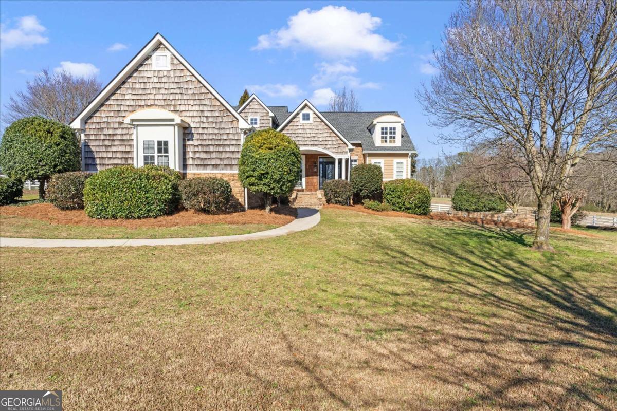 220 McKenzie Bridge Road Carrollton, GA 30117 - Photo 4 of 80 a view of a big house with a small yard plants and large tree