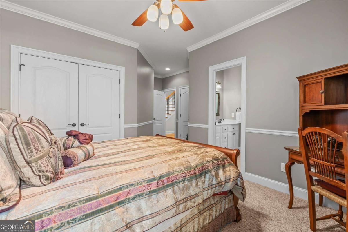 220 McKenzie Bridge Road Carrollton, GA 30117 - Photo 41 of 80 a bedroom with a bed and a chandelier