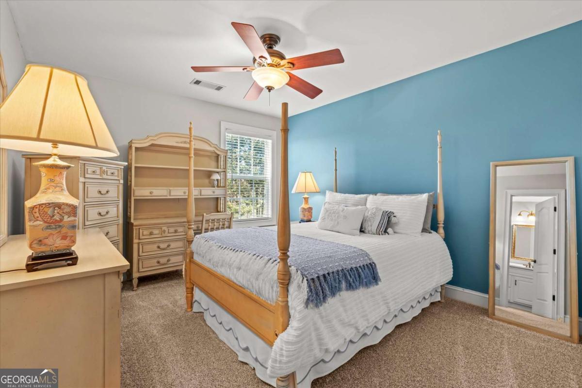 220 McKenzie Bridge Road Carrollton, GA 30117 - Photo 47 of 80 a bedroom with a large bed and a chandelier