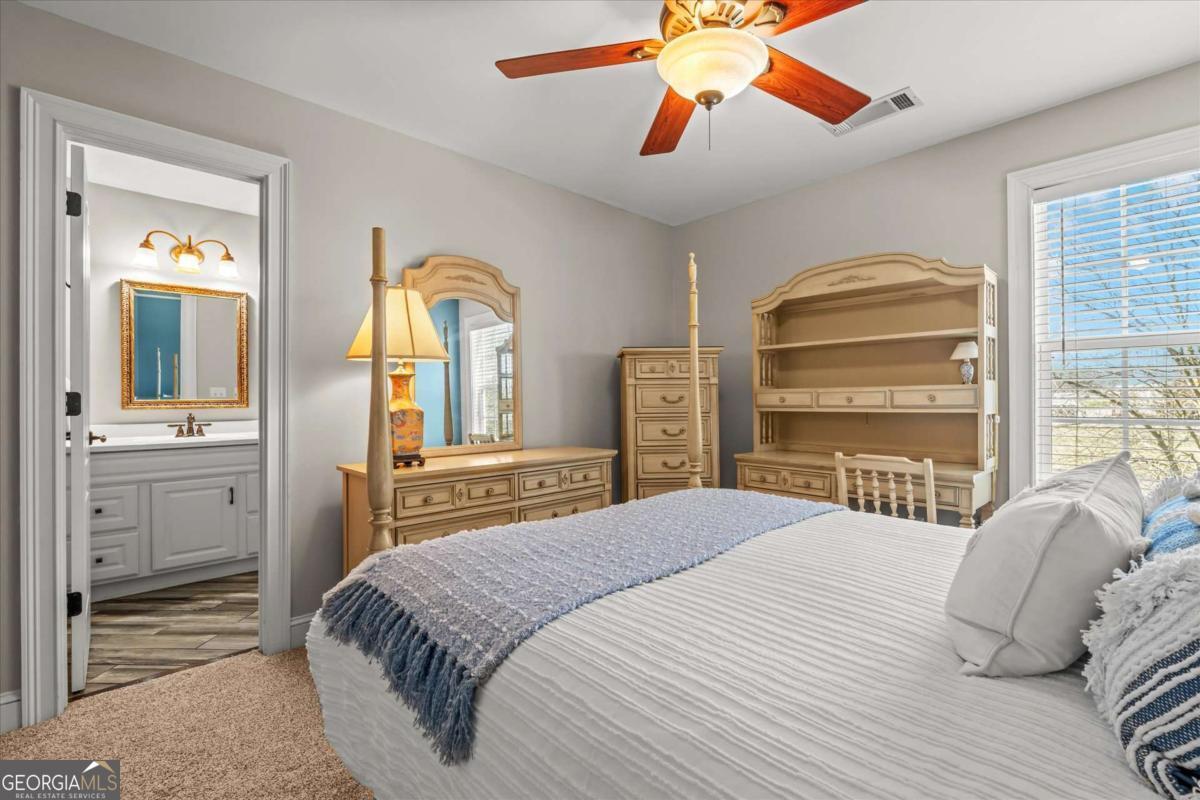 220 McKenzie Bridge Road Carrollton, GA 30117 - Photo 48 of 80 a bedroom with a bed and a chandelier