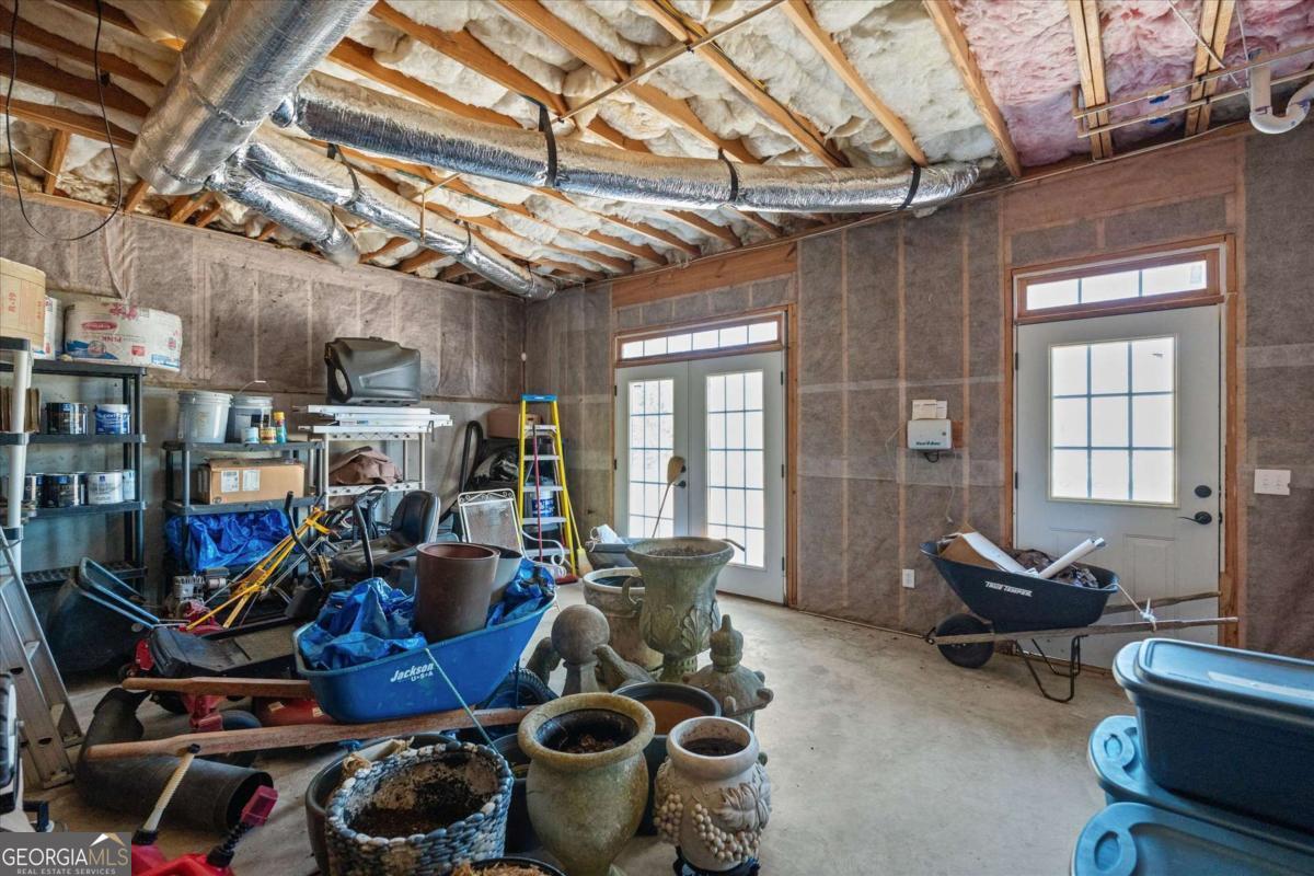 220 McKenzie Bridge Road Carrollton, GA 30117 - Photo 55 of 80 a room with lots of wooden furniture and a chandelier