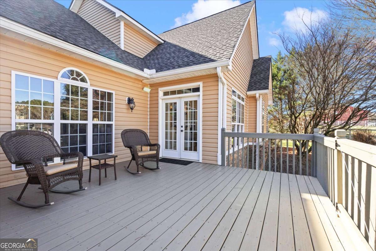 220 McKenzie Bridge Road Carrollton, GA 30117 - Photo 65 of 80 a view of a deck with table and chairs and wooden floor