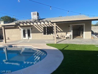2712 Rialto Road Las Vegas, NV 89108 - Photo 20 of 54 Rear view of property featuring stucco siding, an outdoor pool, a pergola, and a patio area