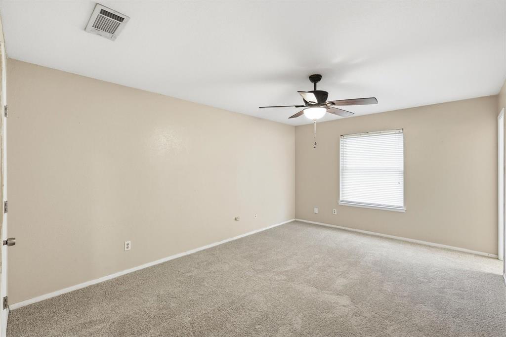 425 Ridgecrest Drive Saginaw, TX 76179 - Photo 15 of 27 an empty room with a window and a ceiling fan