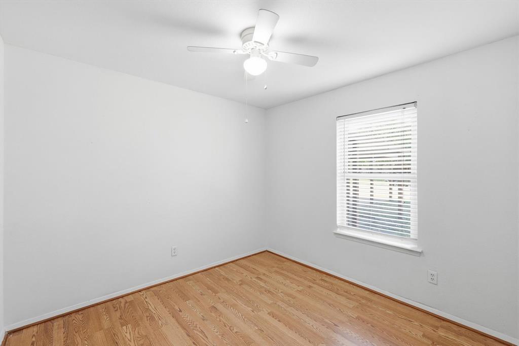 425 Ridgecrest Drive Saginaw, TX 76179 - Photo 19 of 27 an empty room with windows and ceiling fan