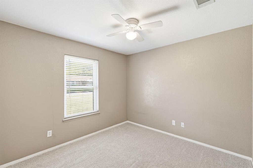 425 Ridgecrest Drive Saginaw, TX 76179 - Photo 21 of 27 an empty room with windows and ceiling fan