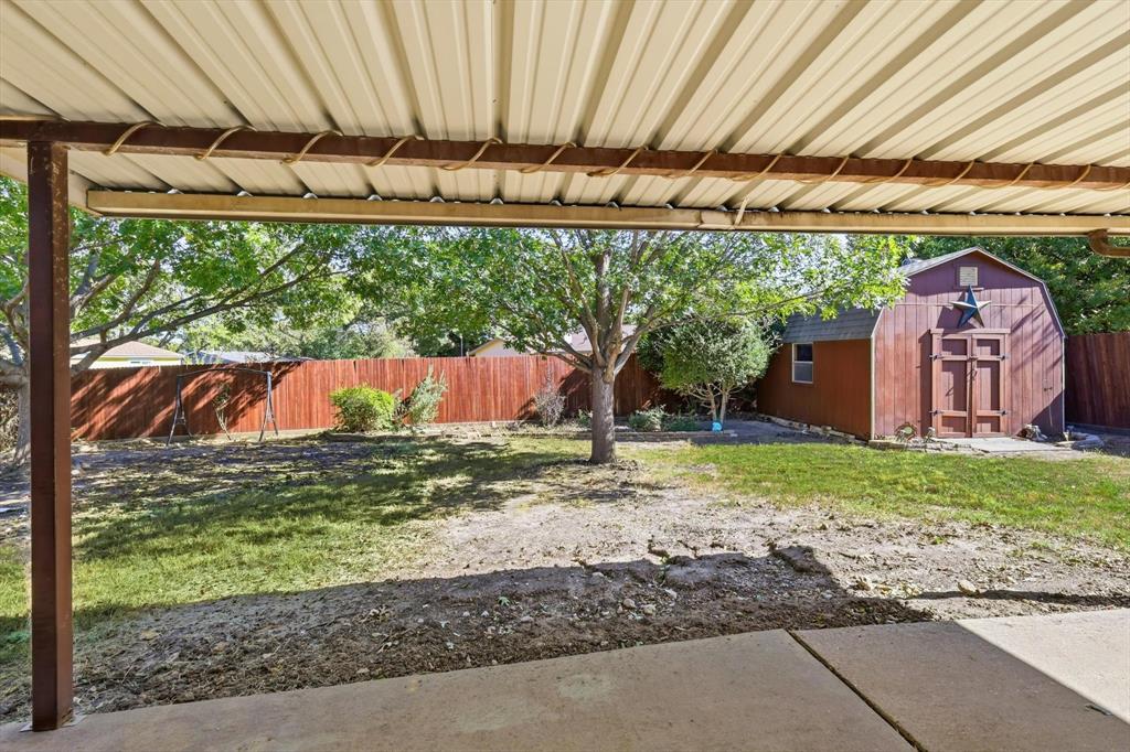 425 Ridgecrest Drive Saginaw, TX 76179 - Photo 22 of 27 a backyard of a house with a garden and outdoor seating