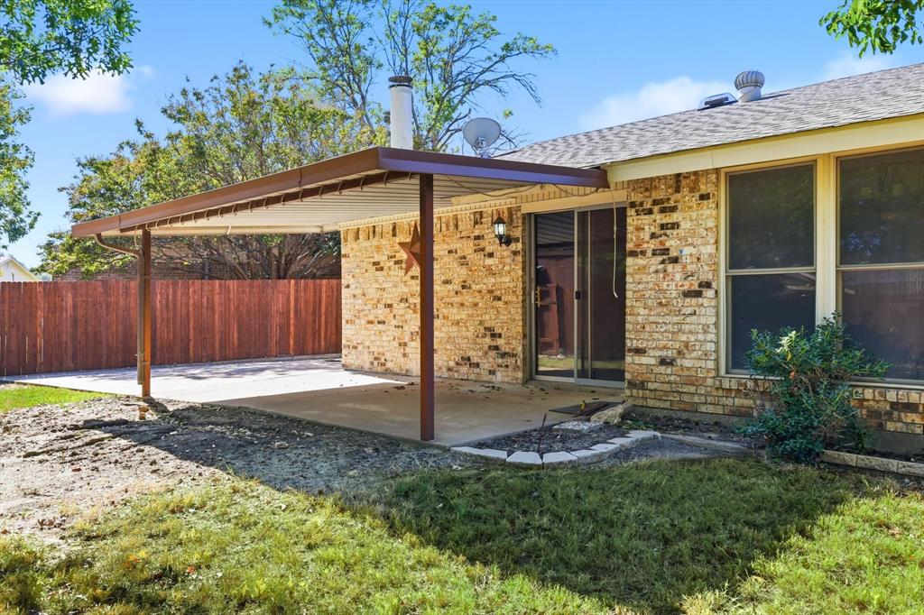 425 Ridgecrest Drive Saginaw, TX 76179 - Photo 25 of 27 a front view of a house with garden