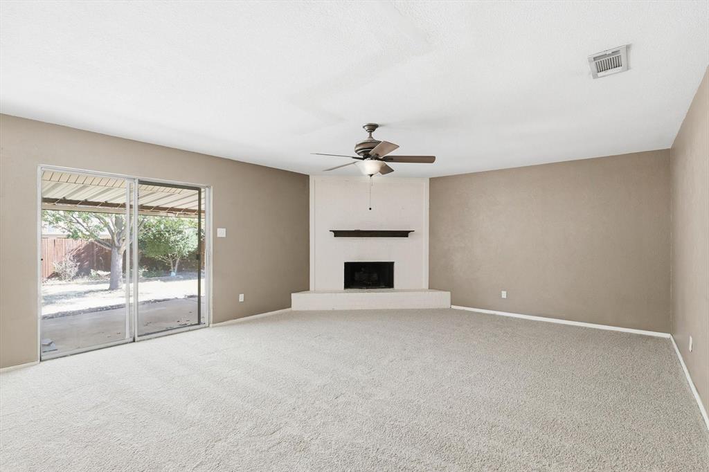 425 Ridgecrest Drive Saginaw, TX 76179 - Photo 8 of 27 a view of an empty room with a fireplace