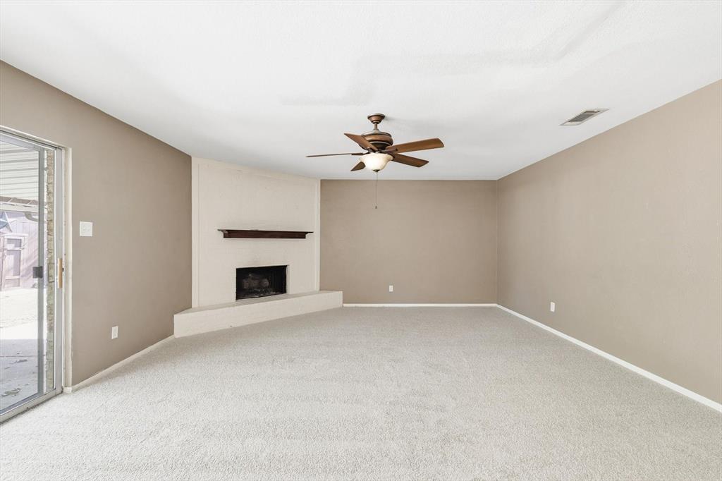 425 Ridgecrest Drive Saginaw, TX 76179 - Photo 9 of 27 a view of an empty room with a fireplace and a window