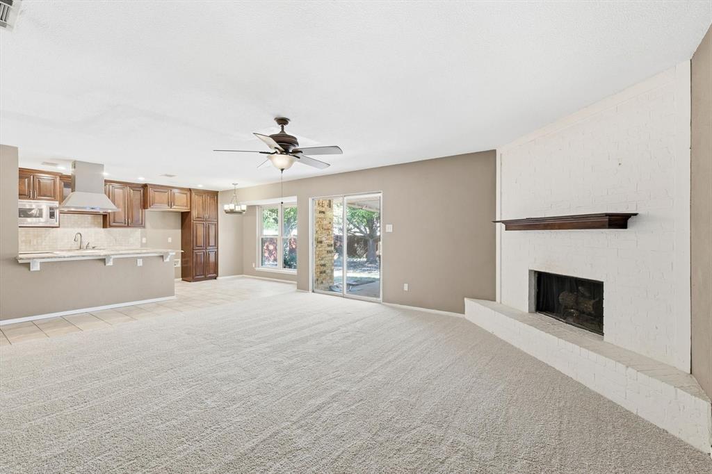 425 Ridgecrest Drive Saginaw, TX 76179 - Photo 10 of 27 a large white kitchen with fireplace and windows