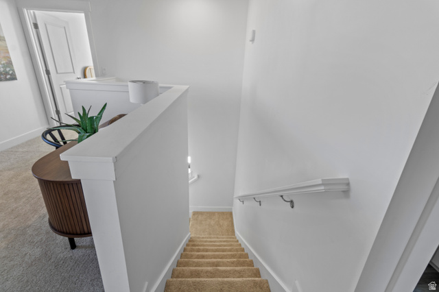 1264 West 500 South, Unit 320 Logan, UT 84321 - Photo 12 of 39 Carpeted staircase with white walls and a white handrail
