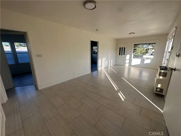 a view of a livingroom with wooden floor and window